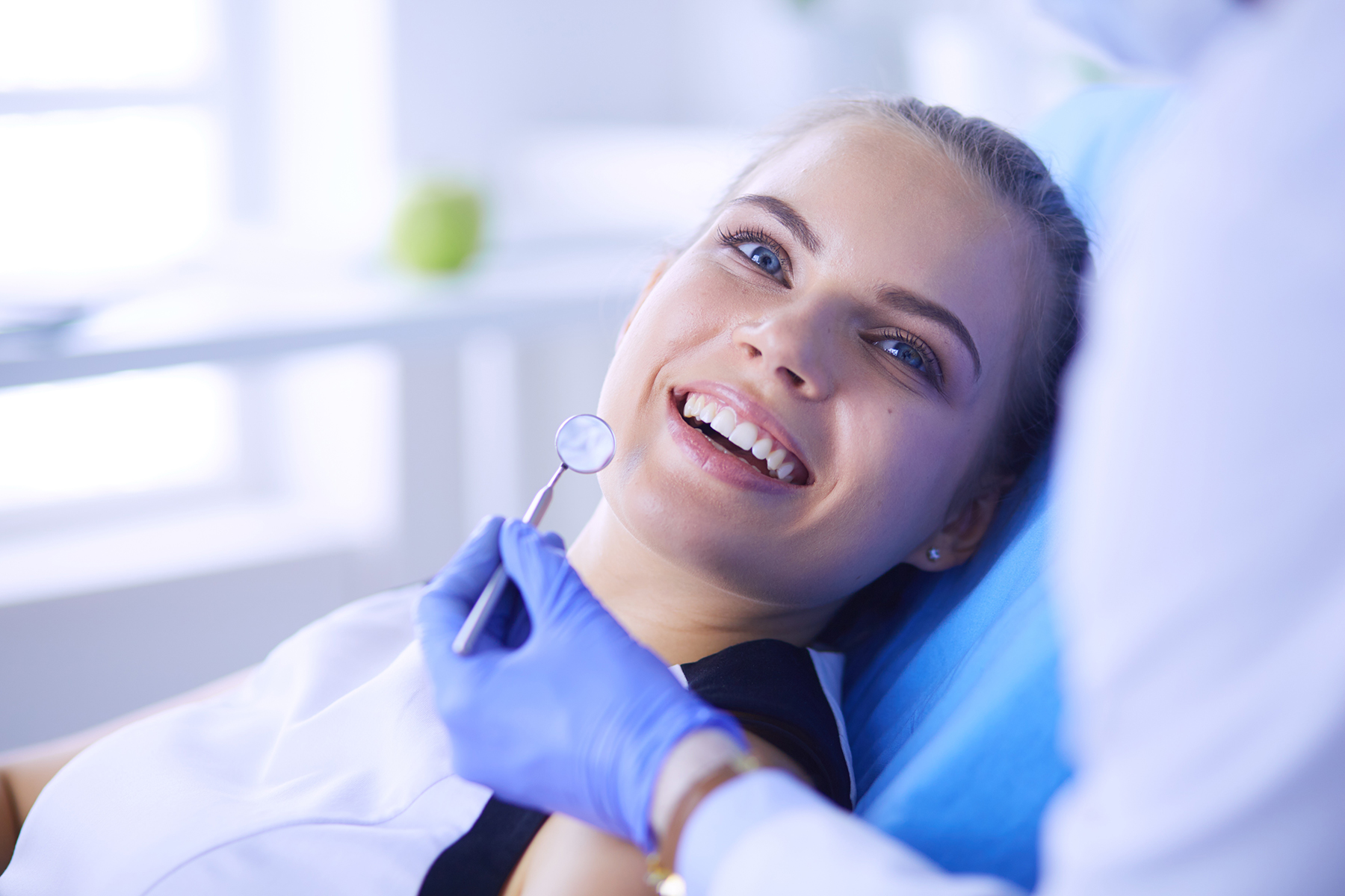 Woman smiling at the preventive dentist in Medford, MA