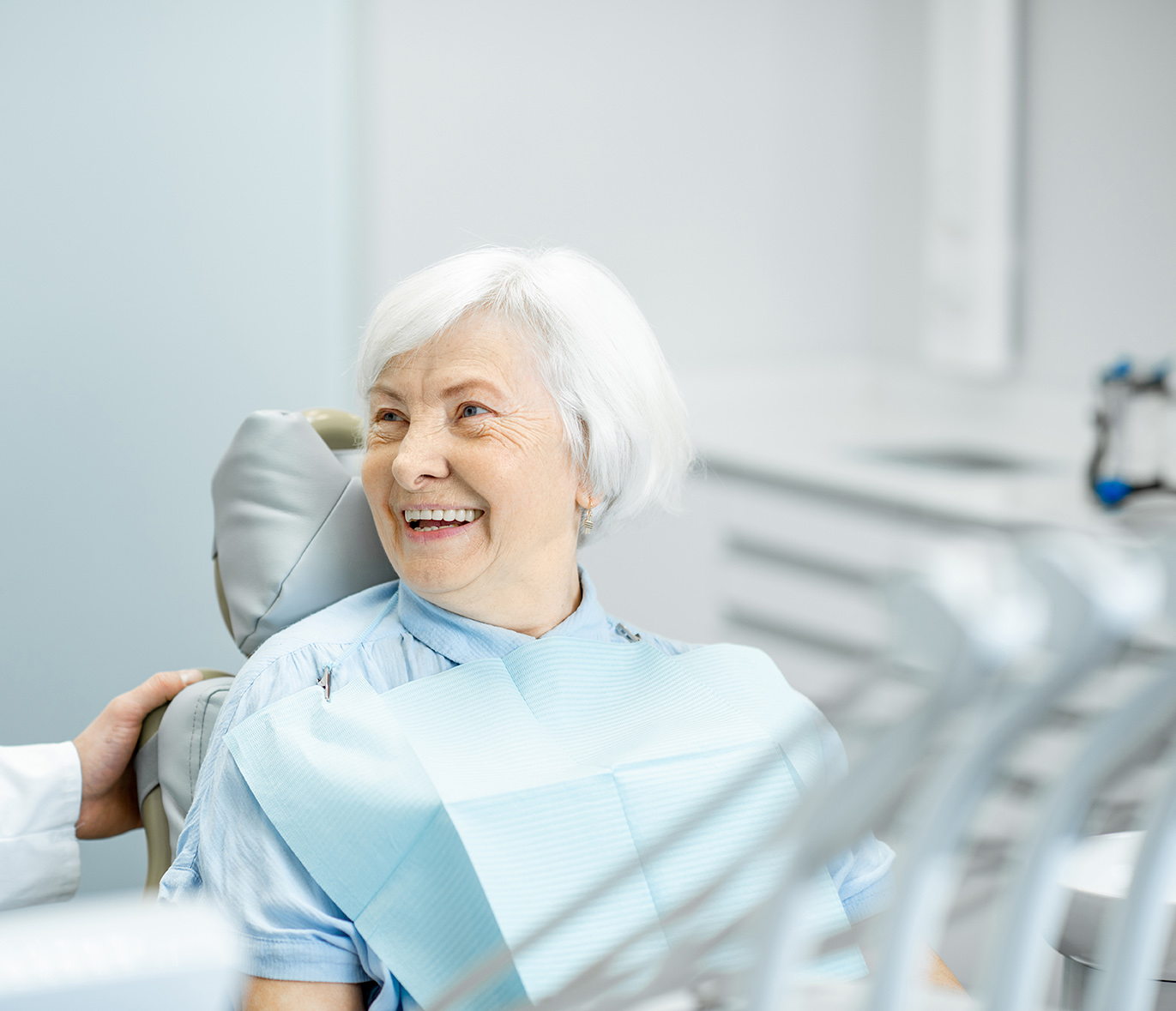 older woman smiling during dentist appointment in medford Massachusetts