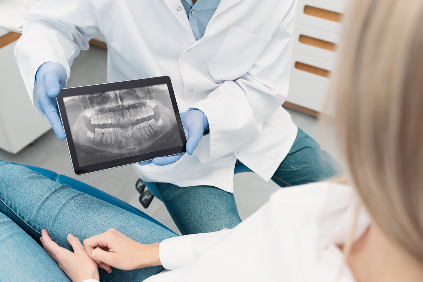 dental patient looking at dental xrays with Dr. Tien Do