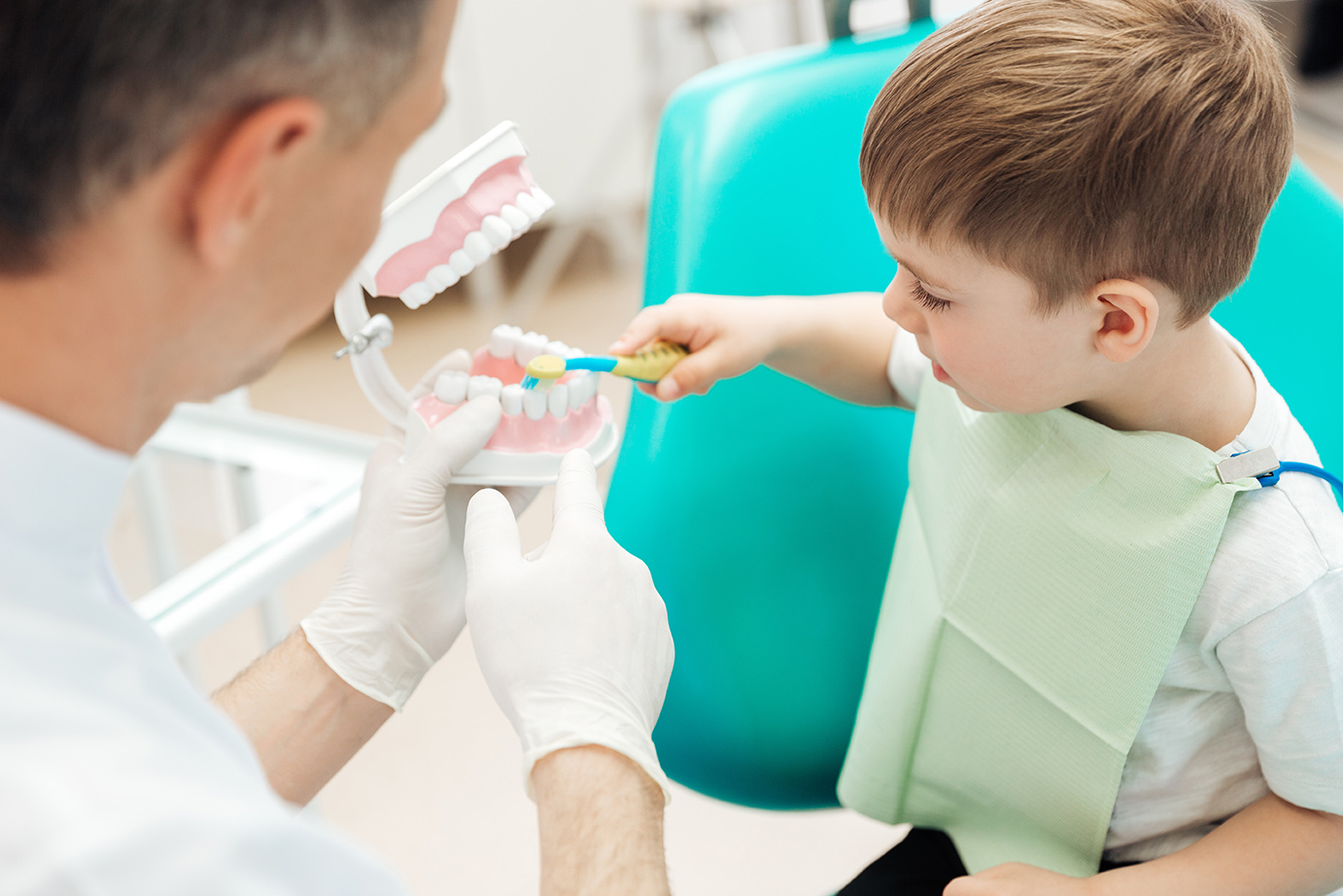 Dr. Tien Do, DMD talking with a child during pediatric dentist appointment in medford ma