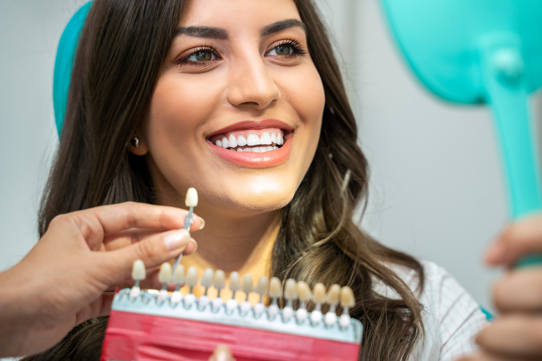 Woman looking at her teeth whitening results at Medford Main Street Dental P.C.