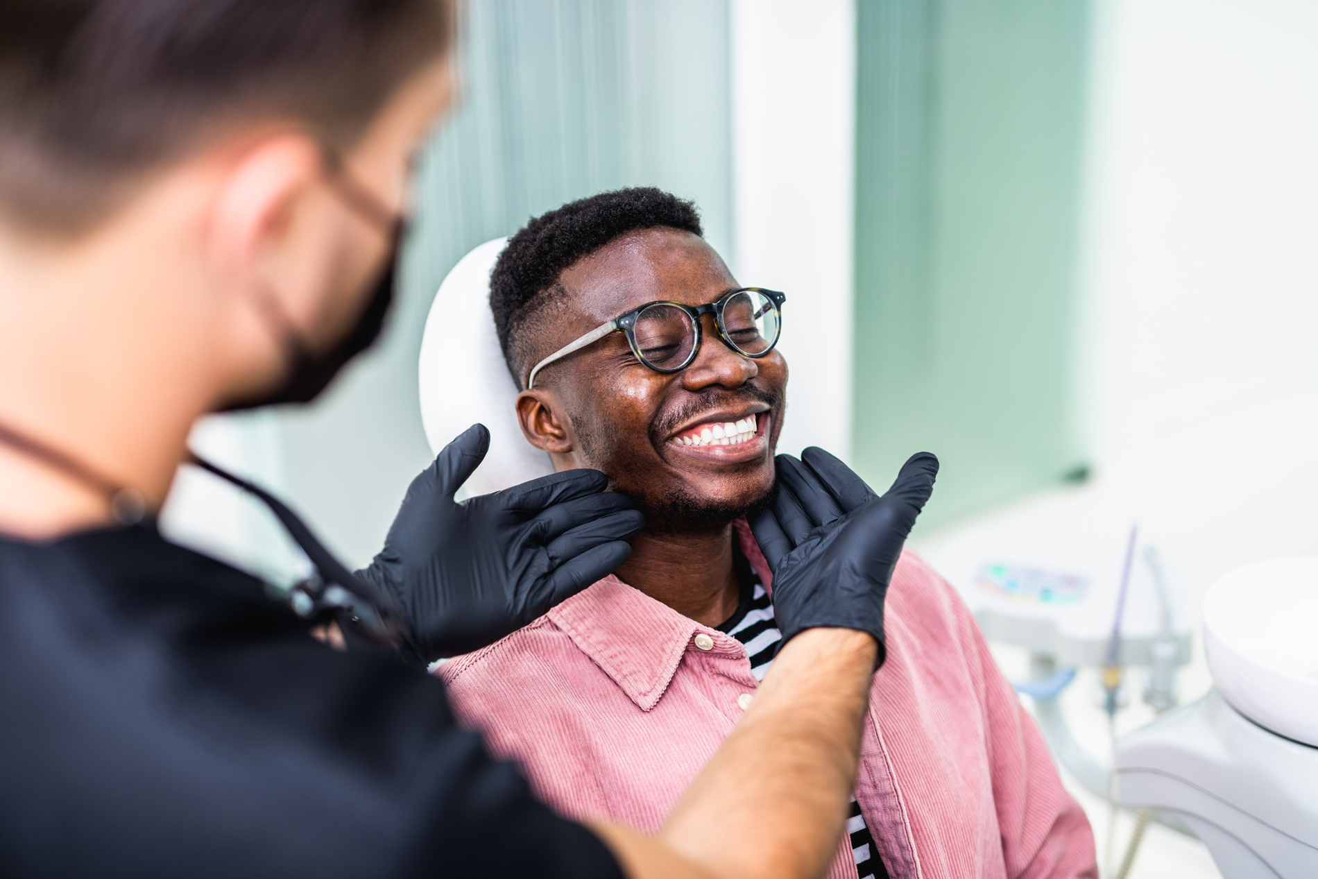 Man smiling at the dentist with his new partial dentures in Medford MA